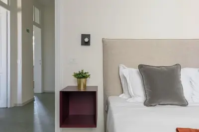 a bedroom with a bed and a table with a plant on it at iFlat Calm & Spacious Apartment in Urban Oasis in Rome