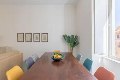 a dining room with a wooden table and chairs at iFlat Calm & Spacious Apartment in Urban Oasis in Rome