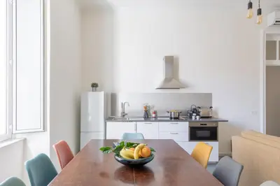 a kitchen with a wooden table with a bowl of fruit at iFlat Calm & Spacious Apartment in Urban Oasis in Rome