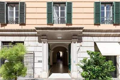an entrance to a building with green shuttered windows at iFlat Calm & Spacious Apartment in Urban Oasis in Rome