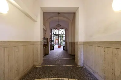an empty hallway in a building with a window at 23 FREE ROME Trastevere in Rome