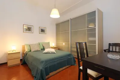 a bedroom with a bed with a table and a dining room at 23 FREE ROME Trastevere in Rome