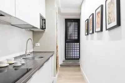 a kitchen with a sink and a counter top at Modern Flat Historic 1200s Palace Steps from Navona in Rome