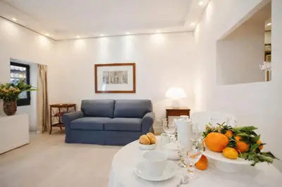 a living room with a table with fruit on it at Modern Flat Historic 1200s Palace Steps from Navona in Rome