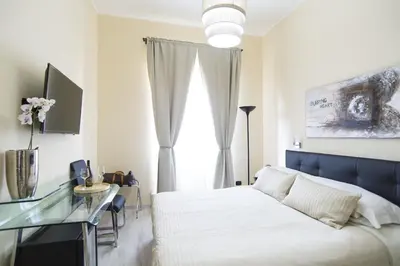 a bedroom with a white bed and a glass desk at Town House 57 in Rome