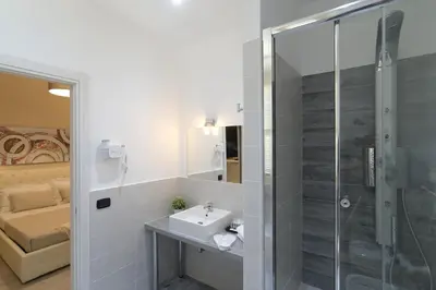 a bathroom with a sink and a shower at Town House 57 in Rome