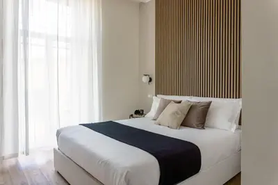 a bedroom with a large white bed with white pillows at Rome Bliss GuestHouse in Rome