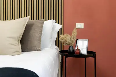 a bedroom with a white bed and a side table at Rome Bliss GuestHouse in Rome