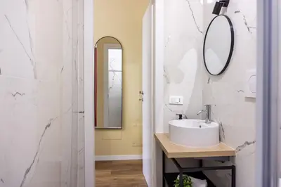 a bathroom with a sink and a mirror at Rome Bliss GuestHouse in Rome
