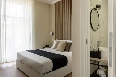 a bedroom with a bed and a mirror and a sink at Rome Bliss GuestHouse in Rome