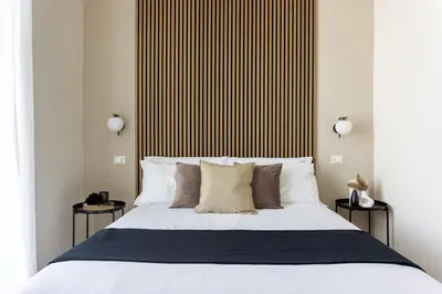 a bedroom with a large bed with two side tables at Rome Bliss GuestHouse in Rome