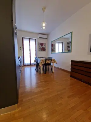 a living room with a table and a dining room at Ponte Lungo Guest House in Rome