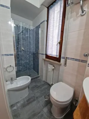a bathroom with a toilet and a sink and a shower at Ponte Lungo Guest House in Rome