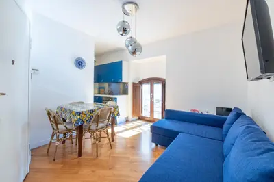 a living room with a blue couch and a table at Elegante dimora - nel centro di Roma in Rome