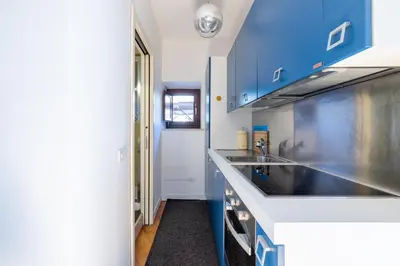 a kitchen with blue cabinets and a sink at Elegante dimora - nel centro di Roma in Rome