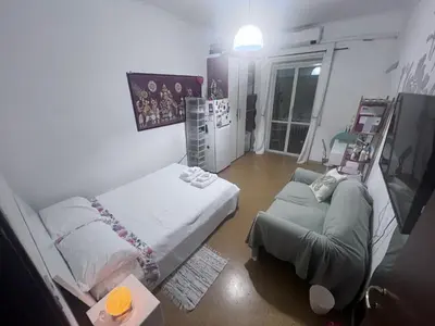 a room with two beds and a tv in it at Na Notte a Roma in Rome