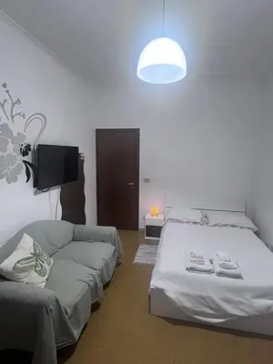 a living room with two beds and a couch at Na Notte a Roma in Rome