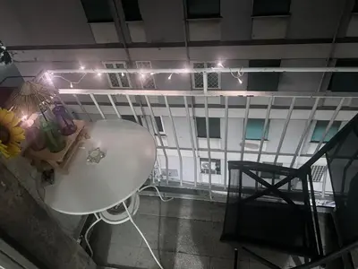 a table and a chair in a room with lights at Na Notte a Roma in Rome