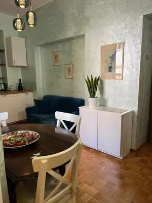 a living room with a table and a couch at Casa Luciano in Rome