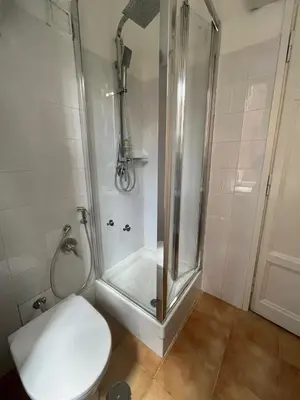 a bathroom with a shower with a toilet and a toilet at Casa Luciano in Rome
