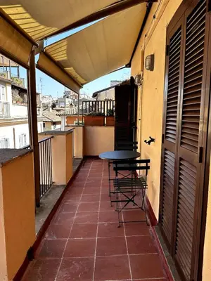 a living room with a couch and a large mirror at Pace Blu Roma in Rome