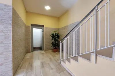 a hallway with stairs and a potted plant at Michele Lux Lodge 6 people Spotless and Connected to Airport and Vatican in Rome