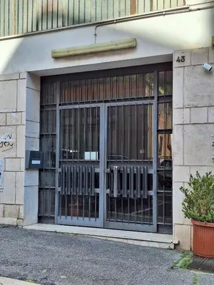 a store front with glass doors on a building at Trinita' dei Monti, night check-in also available in Rome