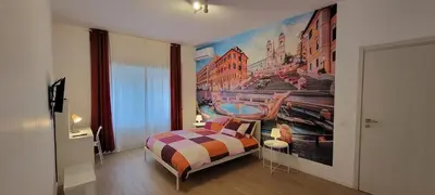 a bedroom with a large painting on the wall at Trinita' dei Monti, night check-in also available in Rome