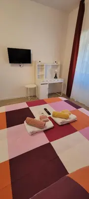 a room with two towels on a colorful floor at Trinita' dei Monti, night check-in also available in Rome