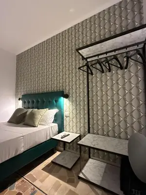 a bedroom with a bed and a bench next to it at Dormire in Trastevere in Rome