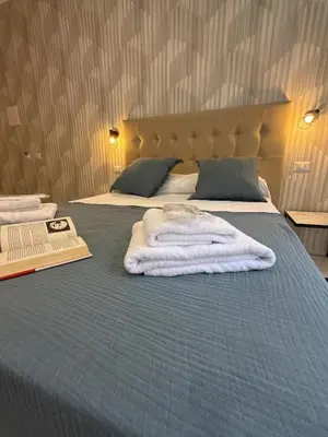 a bedroom with two beds with towels on the bed at Dormire in Trastevere in Rome