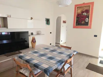 a dining room with a table and chairs and a tv at La Casa dei Melograni in Rome