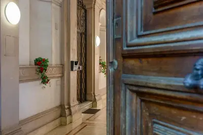 a wooden door with a plant in a hallway at Porta Pia Stay GuestHouse in Rome