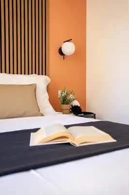 a bed with an open book and a lamp on it at Porta Pia Stay GuestHouse in Rome