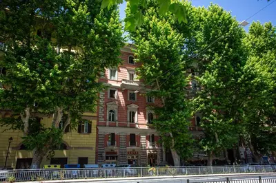 an apartment building with trees in front of it at Porta Pia Stay GuestHouse in Rome