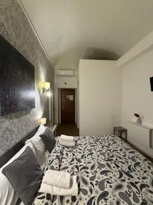 a bedroom with a bed with two towels on it at Suncity Sweet Home in Rome