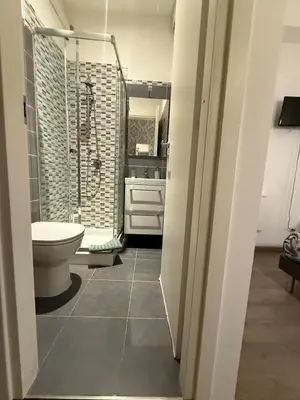 a bathroom with a shower and a toilet and a sink at Suncity Sweet Home in Rome