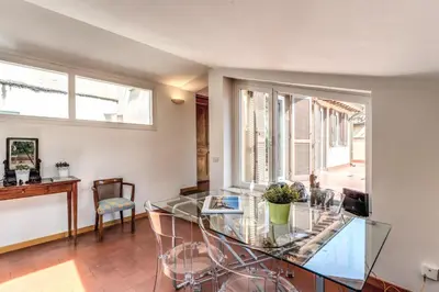 a dining room with a glass table and chairs at Frangipane Colosseum Apartments in Rome