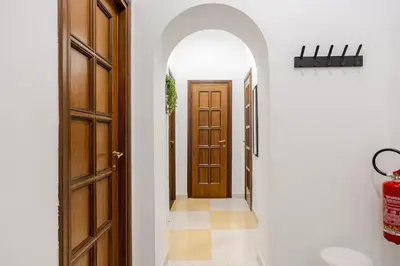 an archway leading to a hallway with a door at Vatican Area Stylish 2BR Fast WiFi & AC in Rome