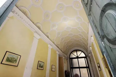 a hallway with a white ceiling with a window at Castro Pretorio Sweet Home in Rome