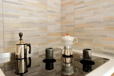 a bathtub with two coffee mugs and a tea kettle at Castro Pretorio Sweet Home in Rome