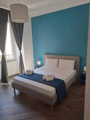 a bedroom with a bed with two towels on it at At Home Gaeta Guest House in Rome