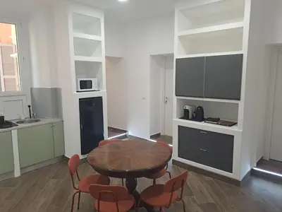 a kitchen with a table and chairs in a room at At Home Gaeta Guest House in Rome