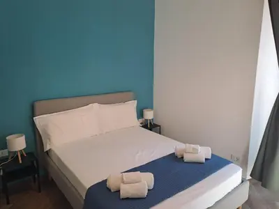 a bedroom with a bed with two towels on it at At Home Gaeta Guest House in Rome