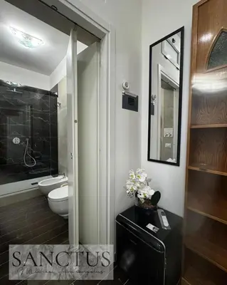 a bathroom with a toilet and a glass shower at Sanctus Michael Archangelus in Rome
