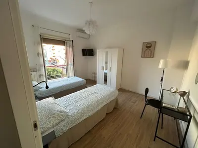 a bedroom with two beds and a window at Casa Susanna in Rome
