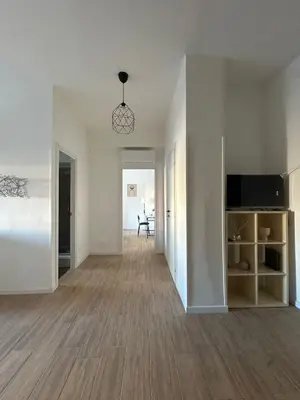 an empty living room with a television and a couch at Casa Susanna in Rome
