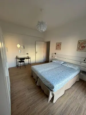 a bedroom with a bed and a table at Casa Susanna in Rome