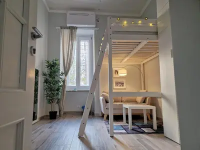 a room with a bunk bed with a ladder at Graziosa camera in posizione strategia con bagno privato esterno in Rome