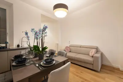 a living room with a table and a couch at A Casa Tua Vatican Suite in Rome